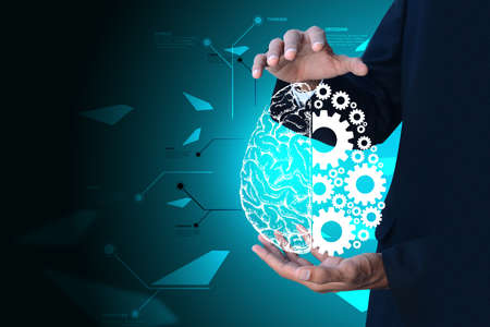 Man showing brain and gear wheels in color back groundの写真素材