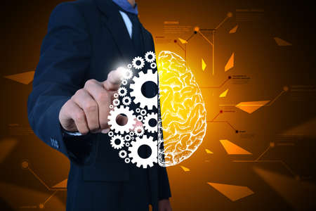 Man showing brain and gear wheels in color back groundの写真素材