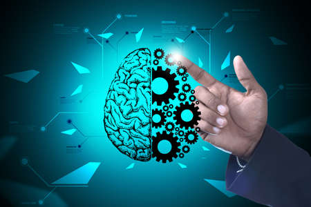 Man showing brain and gear wheels in color back groundの写真素材