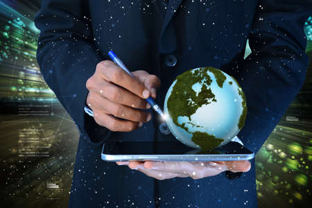 Man with globe and tablet computerの写真素材