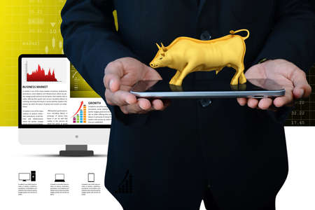 Man hand showing the stock market bullの写真素材