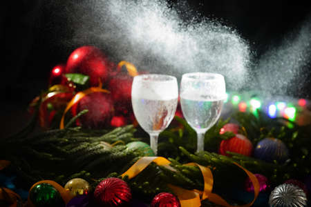 Two champagne glasses and curly ribbons on dark backgroundの写真素材