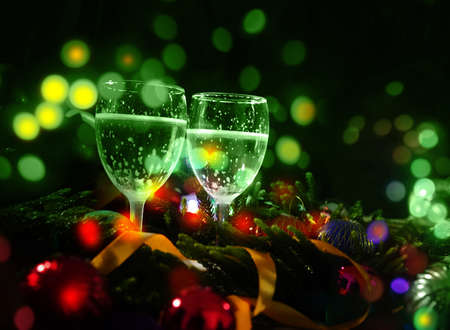 Two glasses of champagne with a Christmas decoration in the backgroundの写真素材
