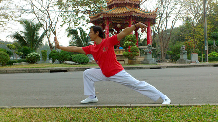 BANGKOK THAILAND  DEC.27: An unidentified man demonstrates the standard post of Chinese gongfu in Lumpini park on December 27 2014 in Bangkok Thailand.のeditorial素材