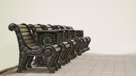 Several benches standing in a row in parke