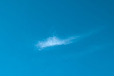 Single white cloud in blue clear sky