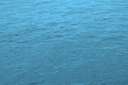 The background of the sea surface is blue in the daytime.の写真素材