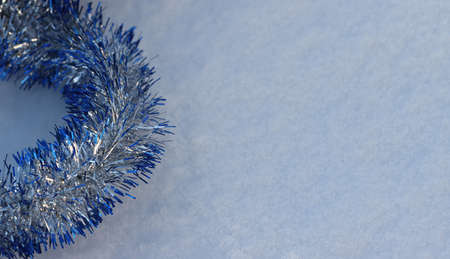 Christmas decorations made of tinsel in the snow.の写真素材