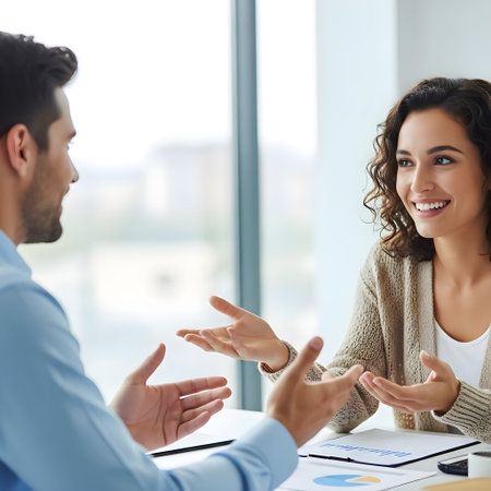 Portrait of happy young businesswoman gesturing at meeting in officeの素材