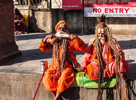 Nepal Sadhu monks - 26 October 2014: Unknown couple of Sadhu monks sitting beside the footpath in  Kathmandu.のeditorial素材