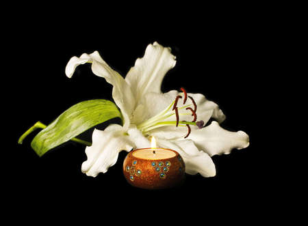 A Candle and Lily on a black backdropの写真素材