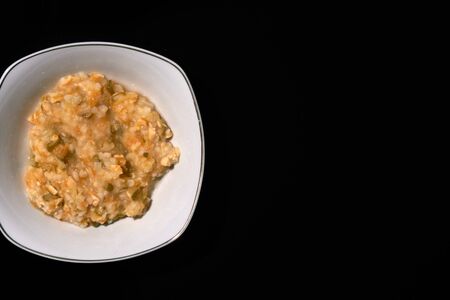 baby food on bowl isolated black background, flat lay top viewの写真素材