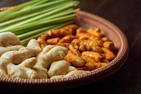 Natural Herbal ingredients with ginger, turmeric and lemongrass on wood backgroundの写真素材