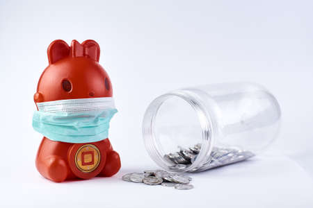 Red Piggy bank wear medical mask on white. health photo conceptの写真素材