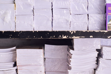 Stacks of paper on a shelf in a store. Close-up