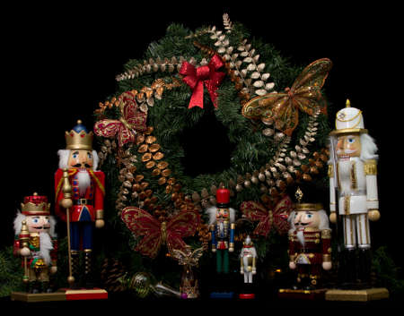 Christmas wooden nutcrackers, wreath, and decorations on black backgroundの写真素材