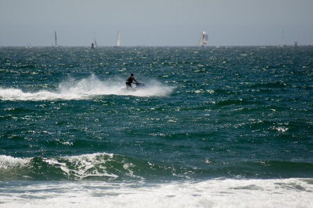 Jet skier riding the pacific ocean waves in Huntington Beach