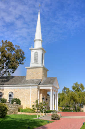 Quaint historic church and steeple with blue skies in the backgroundの写真素材