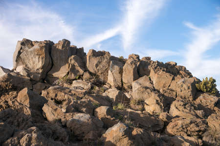 Dawn at Haleakala Volcano National Park.  Rocky cliff with clouds in the background.の写真素材