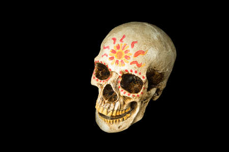 Hand painted Dia de los Muertos (Day of The Dead) skull isolated on black backgroundの写真素材