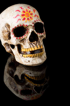 Hand painted Dia de los Muertos (Day of The Dead) skull isolated on black backgroundの写真素材