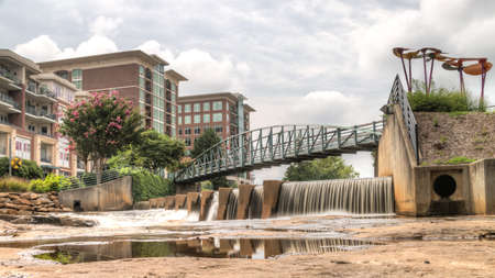 Long exposure captures the slow flowing Reedy River at Falls Parkの写真素材