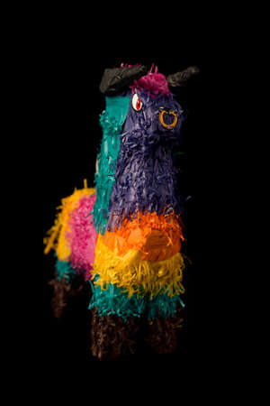 Colorful Mexican pinata decorated as bull isolated on black backgroundの写真素材