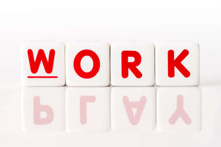 Work spelled in red dice letters with the word play reflected on  isolated white backgroundの写真素材