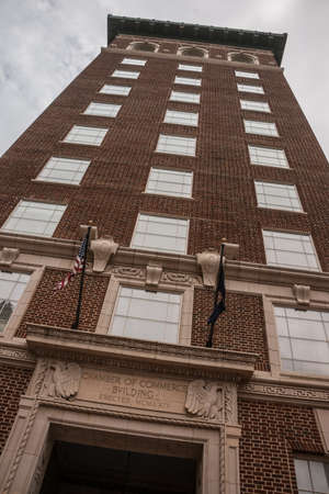Historic brick Chamber of Commerce Building in  downtown Greenville, South Carolina. Dramatic clouds and slightly skewed perspectiveのeditorial素材
