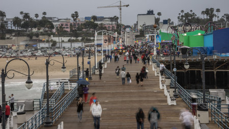 Santa Monica, California USA - February 2015.  Amusement park rides and people in motion at The Santa Monica Pier in Californiaのeditorial素材