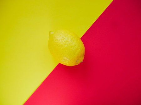 Lemon on a colored background, top view. Trendy colorful photo. Minimal style with colorful paper backdrop. Flat lay fashion concept: lemon on background.の写真素材