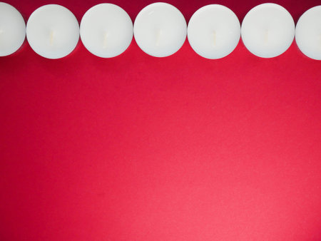 candles. Small candle on red table. Lighter. Professional photo session. Professional photo studio.の写真素材