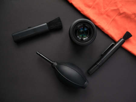 Camera and lens care. Camera cleaning kits and camera gears on colored backgroundの写真素材