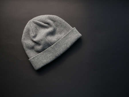 Gray worm winter woolen hat cap flat isolated on black background.の写真素材