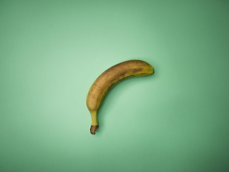 Over ripe bananas isolated on green background.の写真素材