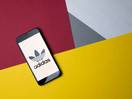 USA - May, 2020; Adidas Iphone Application Screen on colored paper background.のeditorial素材