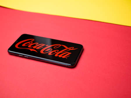 USA - May, 2020; CocaCola Iphone Screen on colored background. #CocaColaのeditorial素材