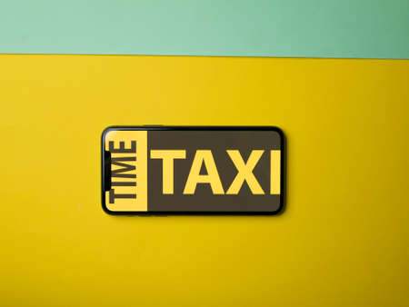 USA - May, 2020; Time Taxi Iphone Application Screen on colored paper background. #TimeTaxiのeditorial素材