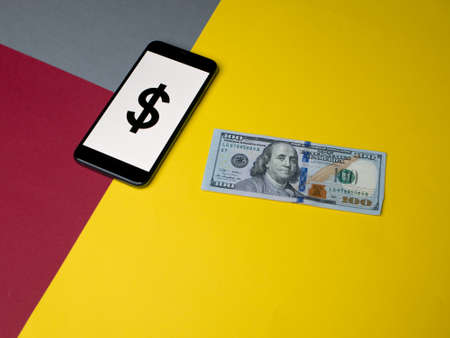 USA - May, 2020; Dollar Iphone Application Screen with money on colored paper background.のeditorial素材