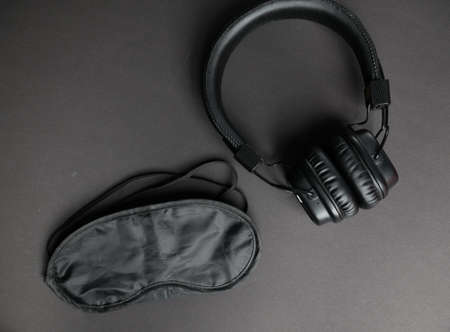 Classic black wired headphones on black paper background. Retro style. 80s. Pop culture.Minimal Music Concept.の写真素材