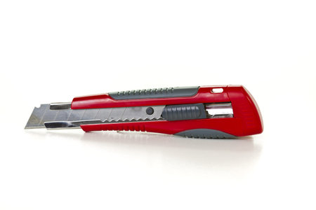 Red utility knife isolated on white background