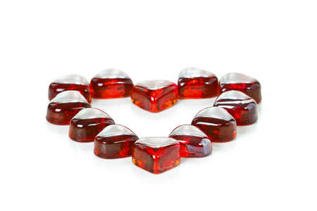 Red heart shaped gems on white backgroundの写真素材