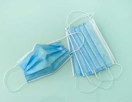 Blue medical doctor face masks photo. Surgical earloop mask for disease prevention.の写真素材