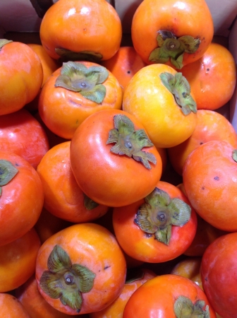 Fresh persimmons for sale at supermarketの素材