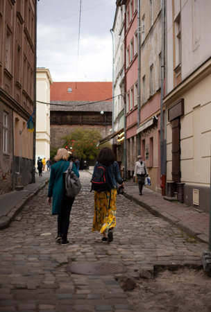 Two women walk in the old city of Lvivの写真素材