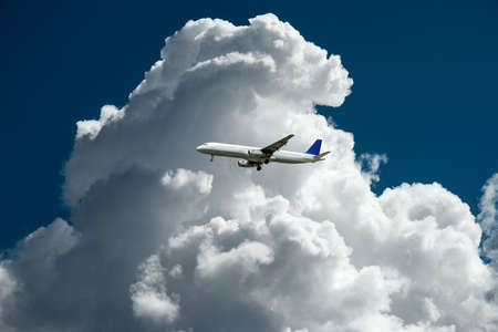 air plane with thunder storm clouds composingの写真素材