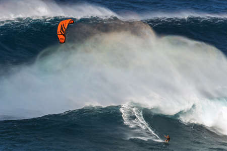 MAUI, HAWAII, USA - DECEMBER 15, 2013: kite surfer is riding a big wave at Jawsのeditorial素材