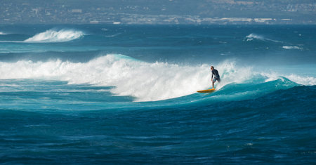 MAUI, HAWAII, USA - DECEMBER 10, 2013: Surfer is riding a wave at hookipa beach