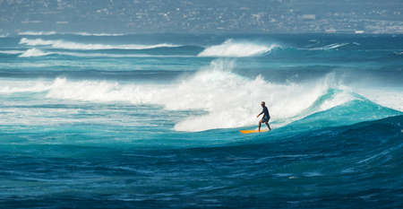 MAUI, HAWAII, USA - DECEMBER 10, 2013: Surfer is riding a wave at hookipa beachのeditorial素材