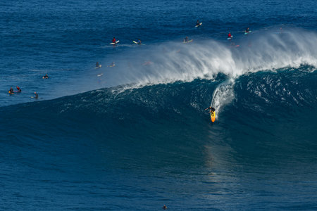 MAUI, HAWAII, USA-DECEMBER 10, 2014: Unknown surfer is riding a big wave at Jaws